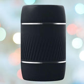 A VeDO Jerk Masturbation Sleeve in black, featuring a clear sleeve, is displayed against a blurred background of colorful bokeh lights.